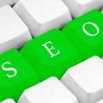 Search Engine Optimization on green computer key.