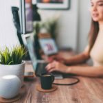 Woman working at home talks to virtual assistant